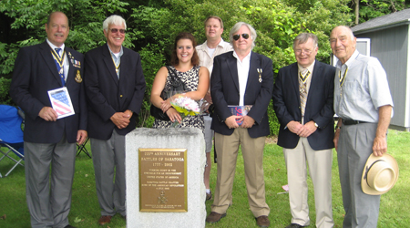 SARs take a photo op with Danielle in front of the monument that we rededicated in 2002. (L-r)Tim Mabee, Duane Booth, Danielle McMullen, Tim Condon, Bill Nottingham, Tom Dunne and John Sheaff
