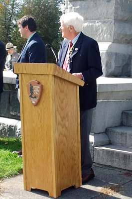 (L-r) Village of Victory Mayor James M. Sullivan and Duane Booth watch the musket salute - Photo: R. Harry Booth