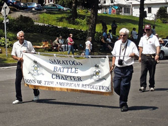 R. Harry Booth and Duane Booth with banner and Saratoga Battle Chapter President Rich Fullam.